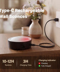 Battery Operated Wall Sconce 2 Pack, Rechargeable Wall Lights for Bedroom charging on a wooden table with decorative flowers.