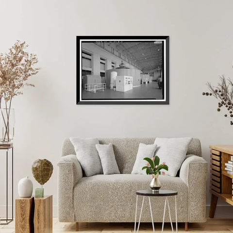 Vintage Framed Print Of Wilson Dam And Hydroelectric Plant Turbine And Generator Unit Spanning The Tennessee River On Wilson Dam Road In Muscle Shoals Alabama A Totally Dope Historical Wall Art For Home Decor From Library Of Congress Archive displayed above a sofa in a living room.