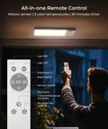 Person using remote to control Rechargeable Motion Sensor Ceiling Light With 12000mAh Battery USB C Charge Remote Control No Brainer LED Ceiling Lamp For Bathroom Pantry Garage Bright Energy Saving Lighting Solution