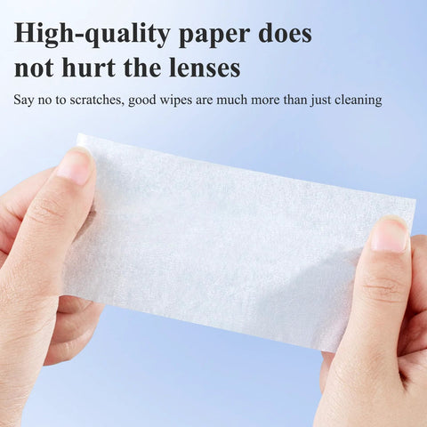 Glasses cleaning wipe, white, pre-moistened, held between fingers