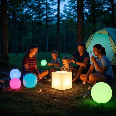 Family camping with Rechargeable 12 Inch LED Light Cube Stool With Remote Control Mood Lamp in various colors illuminating the night.