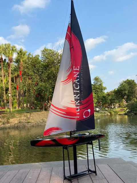 84 Inch Remote Control Sailboat Kit With Preassembled Accessories, shown by a lake, featuring a canvas sail and ABS hull