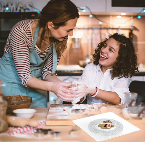 Two people baking in kitchen with Clear 6.4 Inch Square Acrylic Cookie Turntable With Non Slip Mat for cake and cupcake decorating.