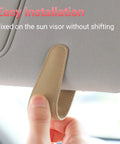 Nifty Beige Sunglass Holder For Car Sun Visor That Snaps Right On to secure glasses, showing easy installation on sun visor.