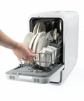 Straight Plug Countertop Dishwasher With No Fuss Setup And Lightning Fast Fifteen Minute Cycle Featuring Slick Touch Interface Auto Dry capability, user loading dishes.
