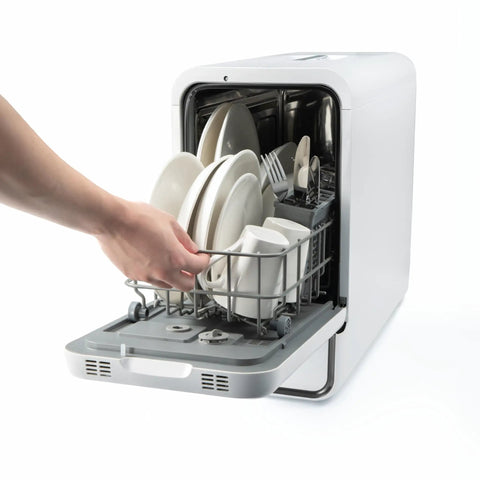 Straight Plug Countertop Dishwasher With No Fuss Setup And Lightning Fast Fifteen Minute Cycle Featuring Slick Touch Interface Auto Dry capability, user loading dishes.