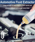 Close-up of a white 200cc automotive fluid extractor syringe in use, drawing oil from an engine fill port.