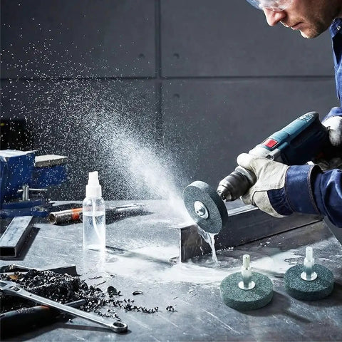 Person using drill with 3-Piece Mounted Stone Grinding Wheel Set with 1/4 Inch Shank for metal grinding on workbench.