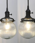 Close-up of globe striped glass shades for Three Light Linear Pendant Island Lighting with 5.9 Inch Globe Striped Glass Shades.