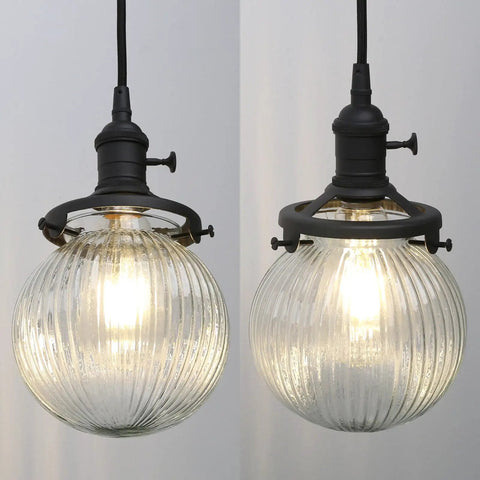 Close-up of globe striped glass shades for Three Light Linear Pendant Island Lighting with 5.9 Inch Globe Striped Glass Shades.