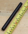 Survival Fire Starter Kit With Drilled Ferrocerium Rod Half Inch By Six Inch Striker on wooden surface with measuring tape