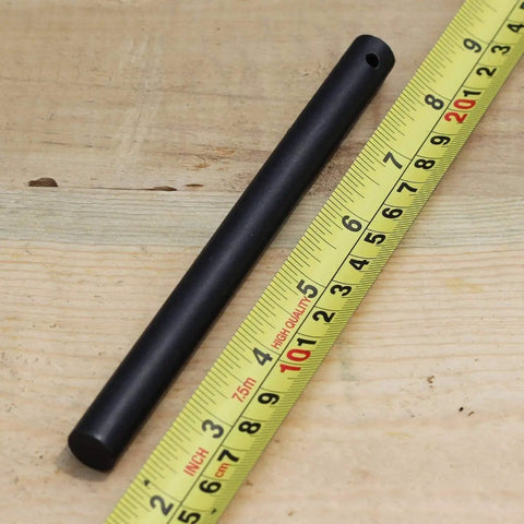 Survival Fire Starter Kit With Drilled Ferrocerium Rod Half Inch By Six Inch Striker on wooden surface with measuring tape