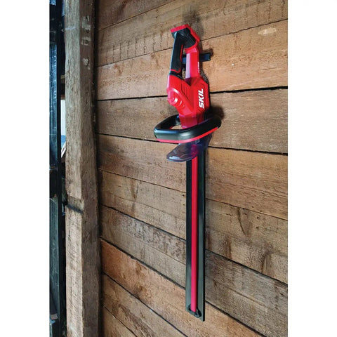 Pwr Core 20 22 Inch Cordless Hedge Trimmer Kit With 2Ah Battery and Charger mounted on wall bracket for easy storage