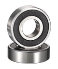 Close-up of two chrome steel 6204RS deep groove bearings with rubber seals; 3/4in bore, 47mm OD, 14mm wide