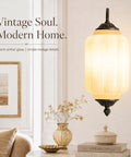 RONGHUAFUGUI Vintage Modern Wall Sconce with Amber Glass mounted on wall, showcasing ornate details and warm amber light.