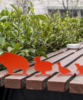Metal Knockover Animal Target Set For Backyard Shooting Practice, 4 Orange Silhouette Targets on wooden bench outdoors