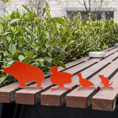 Animal Silhouette Steel Target For Backyard Practice showing orange duck, boar, rat, and bird targets on a bench
