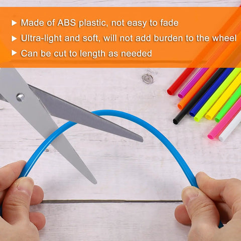 Cutting a blue piece from 72 Pack Universal Spoke Skin Wraps 0.2in Plastic Covers for Dirt Bikes, various colors shown.