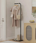 Freestanding Metal Coat Rack With Inverted L Shaped Design And Rock Solid Base Heavy Duty And Stable Clothing Tree For Bedroom Hallway Or Office About 71 Inches Tall Black Finish displaying coats and bags