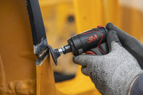 Person using Cubitron II Roloc Fiber Disc 2 Inch 80 Plus Grit Ceramic Abrasive on metal for automotive grinding