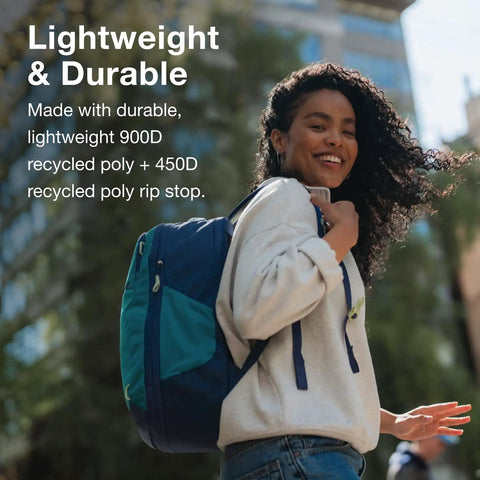 Daylite Expandable 26 Plus 6 Travel Pack Black Lightweight Durable Daypack With 6L Expansion worn by a smiling woman outdoors