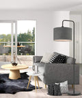 Barden 58 Inch Floor Lamp in Black Finish With Dark Gray Velvet Shade next to gray sofa in modern living room setup