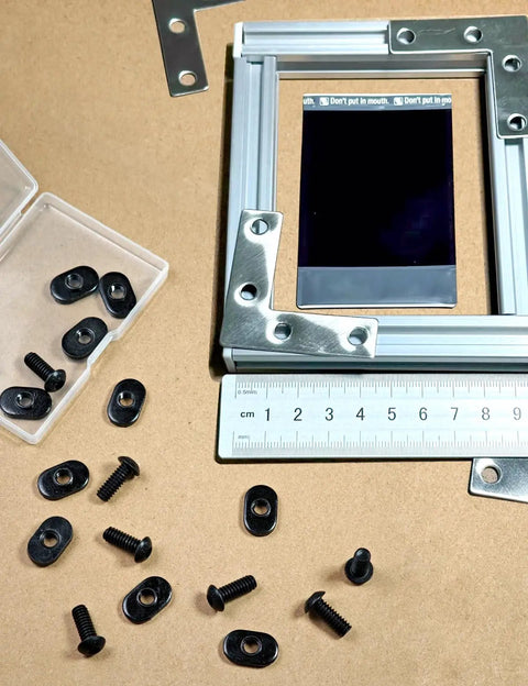 Twenty Pack Black T Slot Nuts For One Quarter Inch By Twenty Threads displayed with aluminum extrusion and ruler