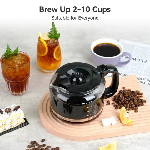 Black coffee pot with coffee beans on a wooden board, surrounded by beverages and pastries, emphasizing brewing 2-10 cups.
