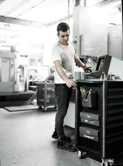 Man using 2Go 4 Tool Quiver Compact Tool Belt Organizer in workshop for quick access and heavy-duty durability, multiple pockets.