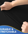 Hands stretching black Elastic Spandex Square Fitted Table Cover 34x34 Inch Two Pack Black Wrinkle Resistant Stain Resistant Durable Polyester Blend No Fuss Easy Fit For Card Folding Tables Great For Kitchen Dining Picnic Patio And Outdoor Parties