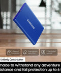 Blue T7 Portable SSD 1TB External Solid State Drive with USB 3.2 Gen 2, shown floating, features durable aluminum body for shock resistance.
