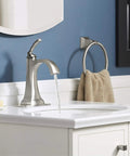 Ridgeport Single Control Lav Faucet With Brushed Nickel Finish mounted on a bathroom sink with running water and modern decor.