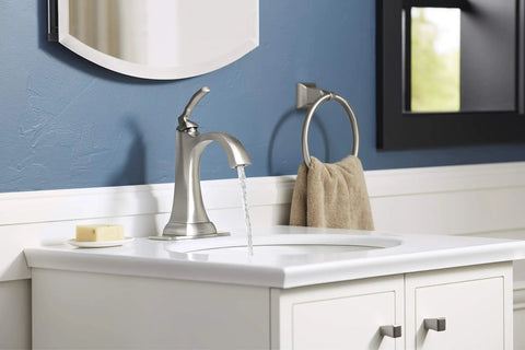Ridgeport Single Control Lav Faucet With Brushed Nickel Finish mounted on a bathroom sink with running water and modern decor.