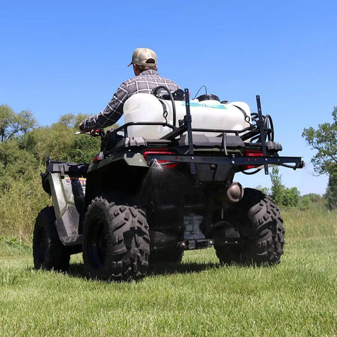 Person operating ATV with Beefy 15 Gallon ATV Broadcast Sprayer With 7 Ft Swath, 2.2 GPM Pump, 70 PSI Max, All Steel Boom on grass