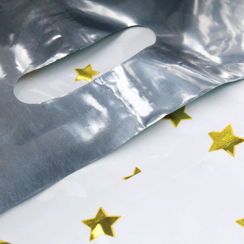 Close-up of 25 Party Favor Bags For Kids Birthday Parties With Star Pattern In 5 Colors, Durable Reusable Goodie Bags For Candy Treats.
