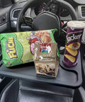 Steering Wheel Desk For Laptop And Eating Two In One Car Tray With Cup Holder Pen Slot And Flat Surface For On The Go Food Or Drinks Multipurpose Travel Car Accessory Car Seat Tray Console That Converts Your Ride Into A Workstation Black with snacks placed on it