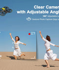 Kid Friendly Camera Drone With Built In 4.5 Inch Live Display Controller showcasing clear 180° adjustable lens capturing woman jumping in desert.