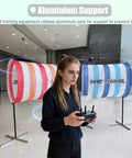 Person operating remote control near DIY Drone Obstacle Course Kit For FPV Racing, Beginner Friendly Practice Set with cloth obstacles.