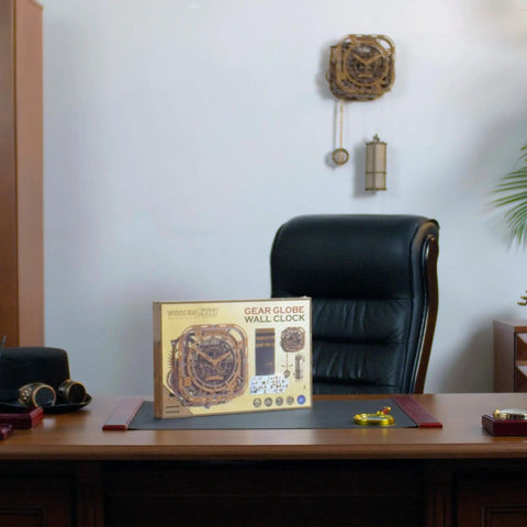 Gear Globe Wall Clock Kit With 369 Laser Cut Pieces displayed on a wooden desk in an office setting.