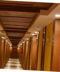 Premium Stainless Steel Fire Sprinkler Head Deflector in hotel corridor designed to protect fixtures from bumps and dents.