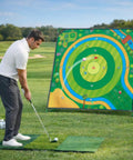 Golfer using Ultra Large 70x70 Inch Golf Chipping Net for backyard practice with 40 training balls and 3 turf hitting mat.