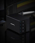 Heavy Duty Four Bay USB C Docking Station For External Hard Drive Enclosure And SSD HDD Expansion With Blazing Fast 10Gbps Transfer Speeds Built Tough Multi Drive Access on a desk with dark background.
