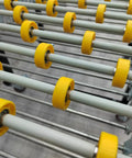 Close-up of 23.6 Inch Wide Portable Flexible Conveyor Roller Table, Unpowered, showing yellow rollers and metal frame.
