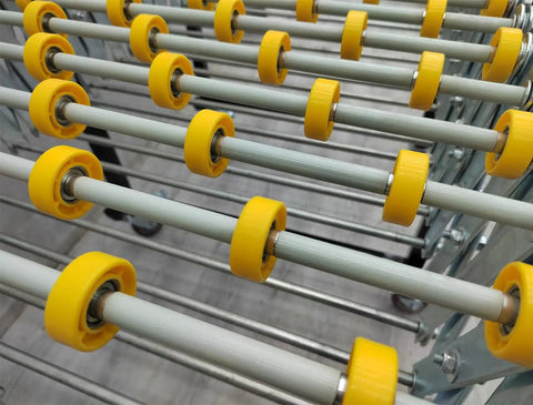 Close-up of 23.6 Inch Wide Portable Flexible Conveyor Roller Table, Unpowered, showing yellow rollers and metal frame.