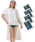 Person wearing clear rain poncho over clothes; product packaging shown; Clear Rain Ponchos For Adults With Hood 4 Pack Lightweight Tear Resistant Emergency Rain Gear For Travel And Outdoor Adventures One Size Fits Most Ideal For Rainy Travel Or Camping Trips