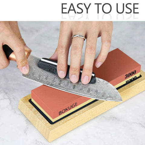 Person sharpening knife on Pro Knife Sharpening Stone Kit With 4 Sided Grit 400/1000/3000/8000 on bamboo base.