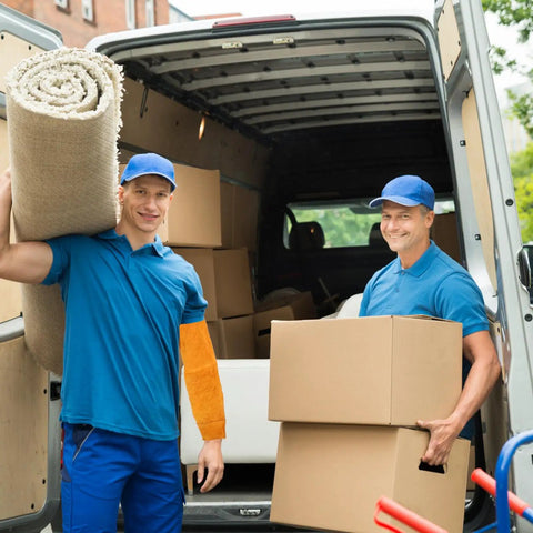 Two men wearing blue shirts and caps carry items in a van, one with Pro Level Heavy Duty Cowhide Leather Arm Sleeves Heat Resistant.