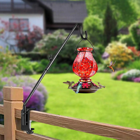 Heavy Duty 20 Inch Deck Hook With Swivel Wing Nut Design For Hummingbird Feeders holds a red feeder on a wood railing.
