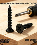 Close-up of Go-To Drywall Screws Kit With 220 Black Wood Screws, showing two screws on wood with screwdriver nearby.
