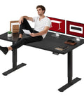 Man relaxing at Heavy Duty Dual Motor Electric Standing Desk 71 By 32 Large Height Adjustable Sit Stand Workstation in home office.